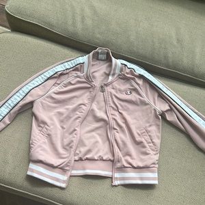 Light pink champion jacket with branding on sleeves